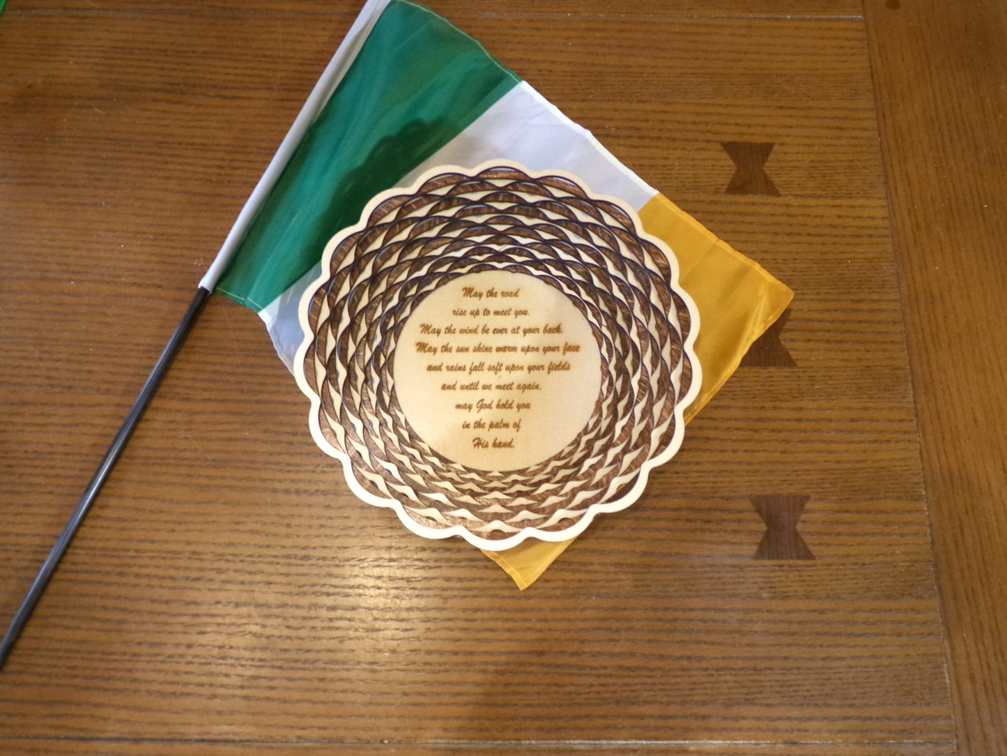 The traditional Irish blessing and prayer for those who want to bestow favor to others on their journey of life. This uniquely designed basket is made with alternating light and dark stained rings that create a beautiful, patterned wall art. This piece is 10 5/8" diameter and 2 5/8" high.