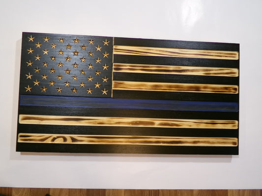 These wooden American blue line  flags are locally sourced from pine and finished with environmentally responsible products. The rustic torched finish shows a unique flair making each piece completely special. Stars are carved not merely painted or applied. The proprietary hanger design incorporates a heavy-duty cable system for mounting. The full sized 30" x 16" flags are large enough to be a focal point in any room or man cave.